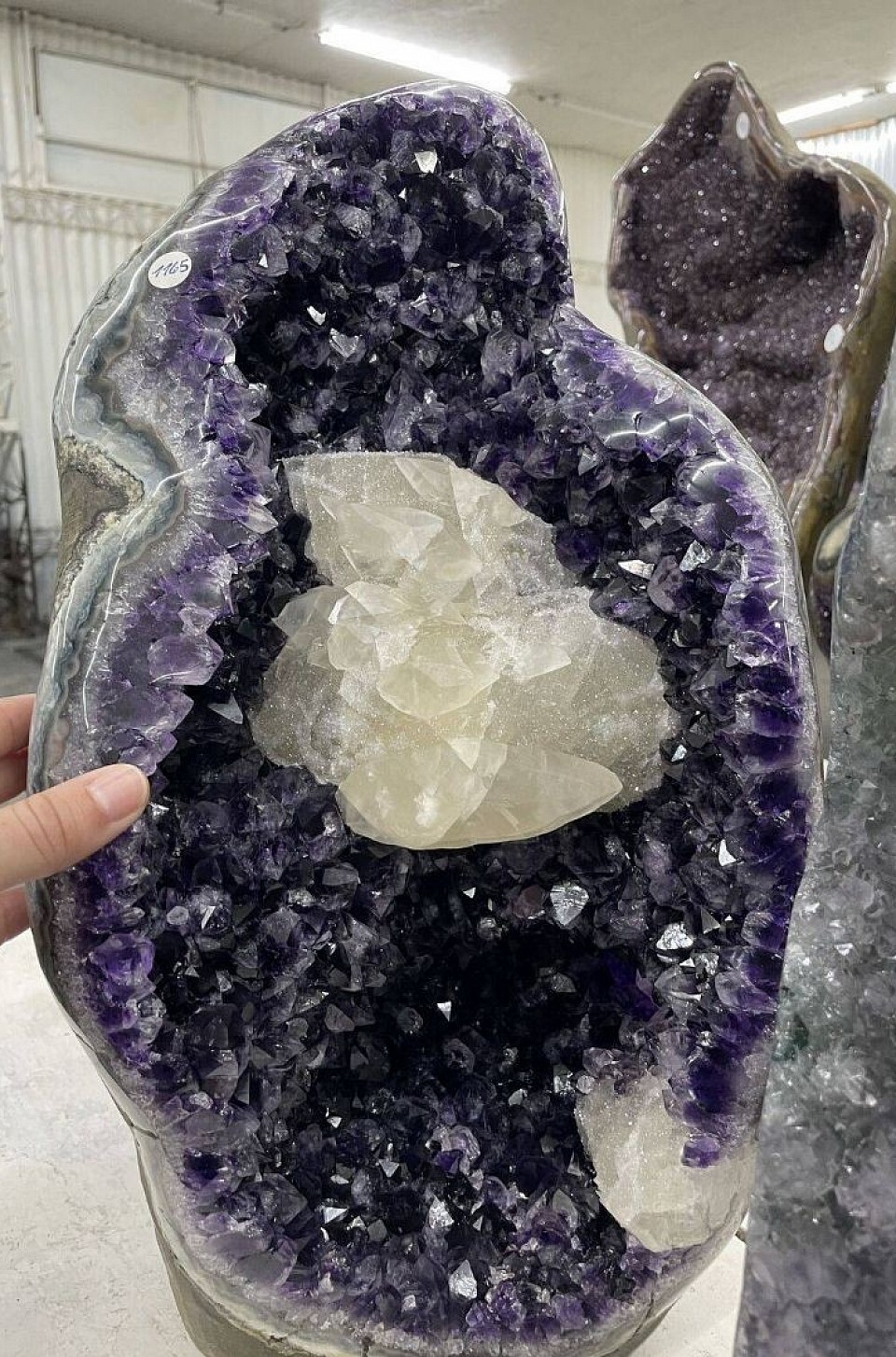 Large amethyst geode with white calcite crystal formation inside